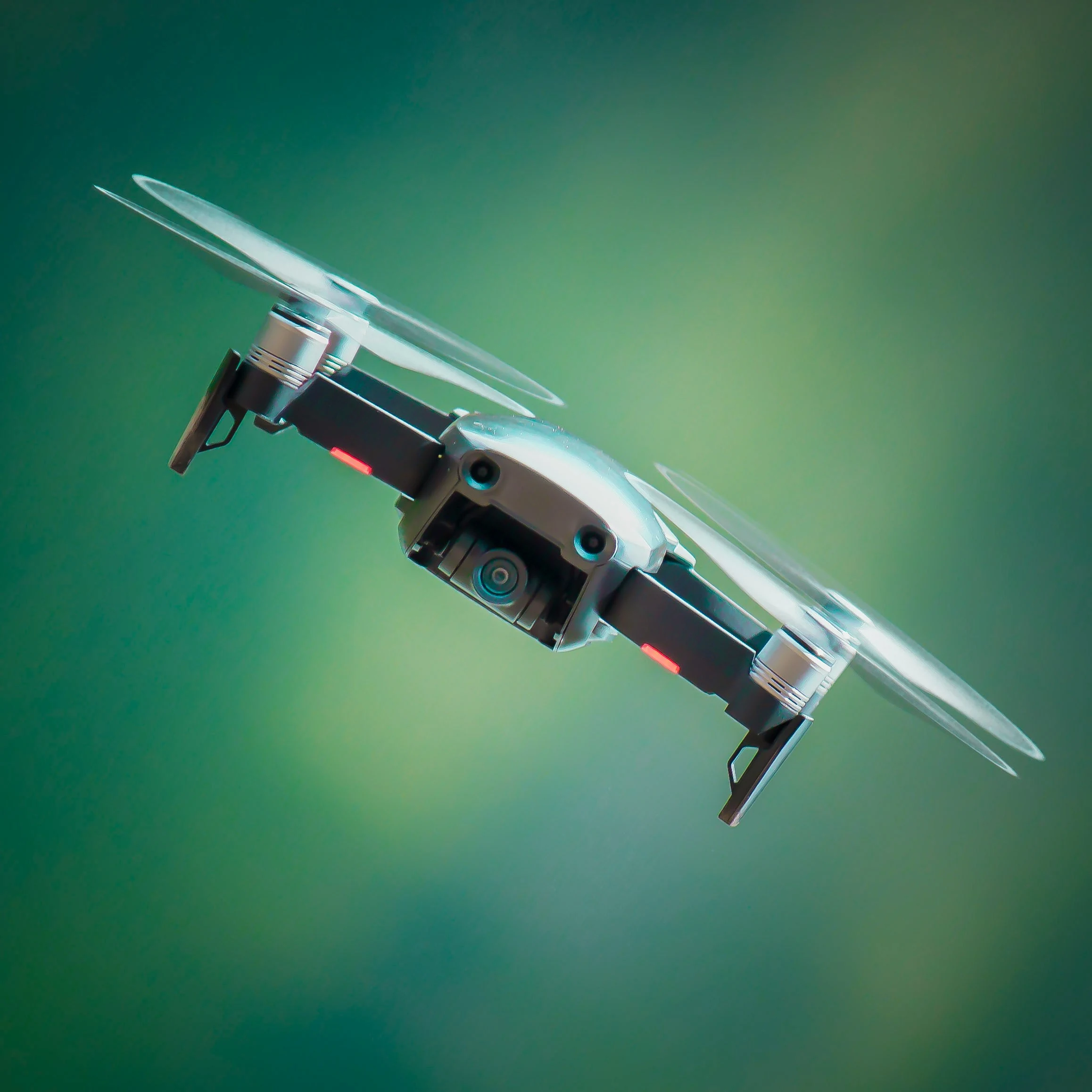 Close-up of a quadcopter against a green background.